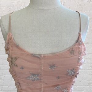 Blush pink colored cami top with silver and gold stars from Altar'd State